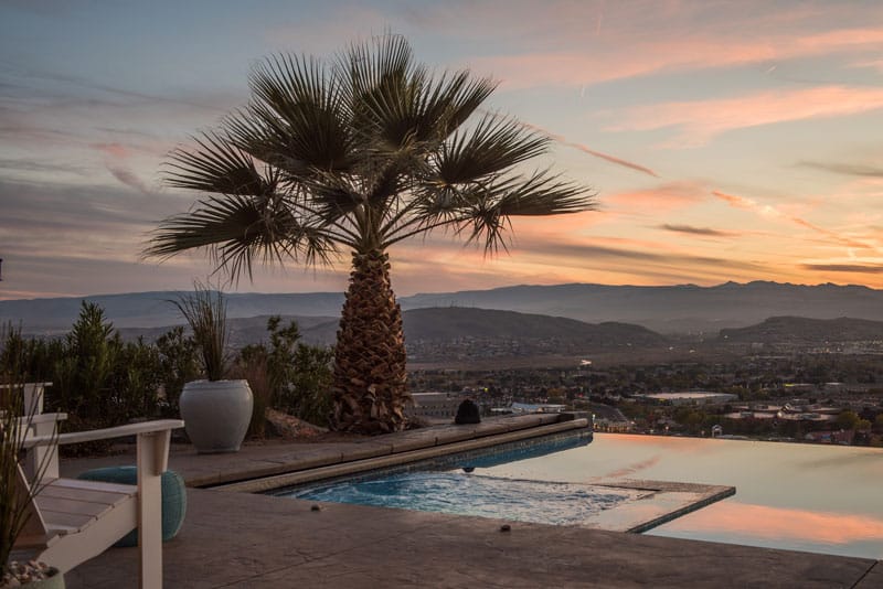 House in a plateau with a front view of a city the vast landscape of Southern Utah